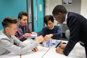An image showing a group of students working together on a practical task