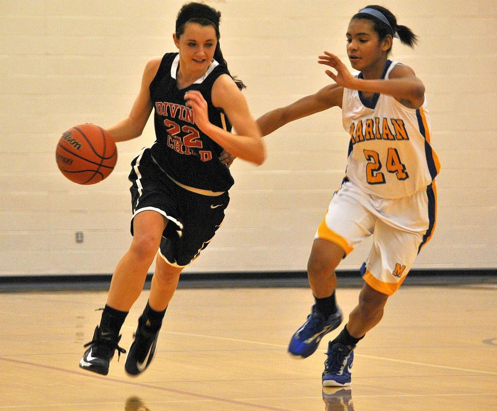 An image of two students playing basketball