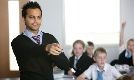 An image showing a teacher asking students questions in a classroom