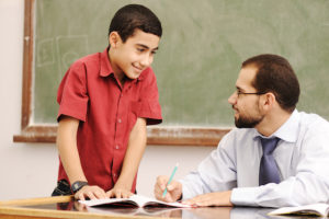 An image of a student getting verbal feedback from a teacher