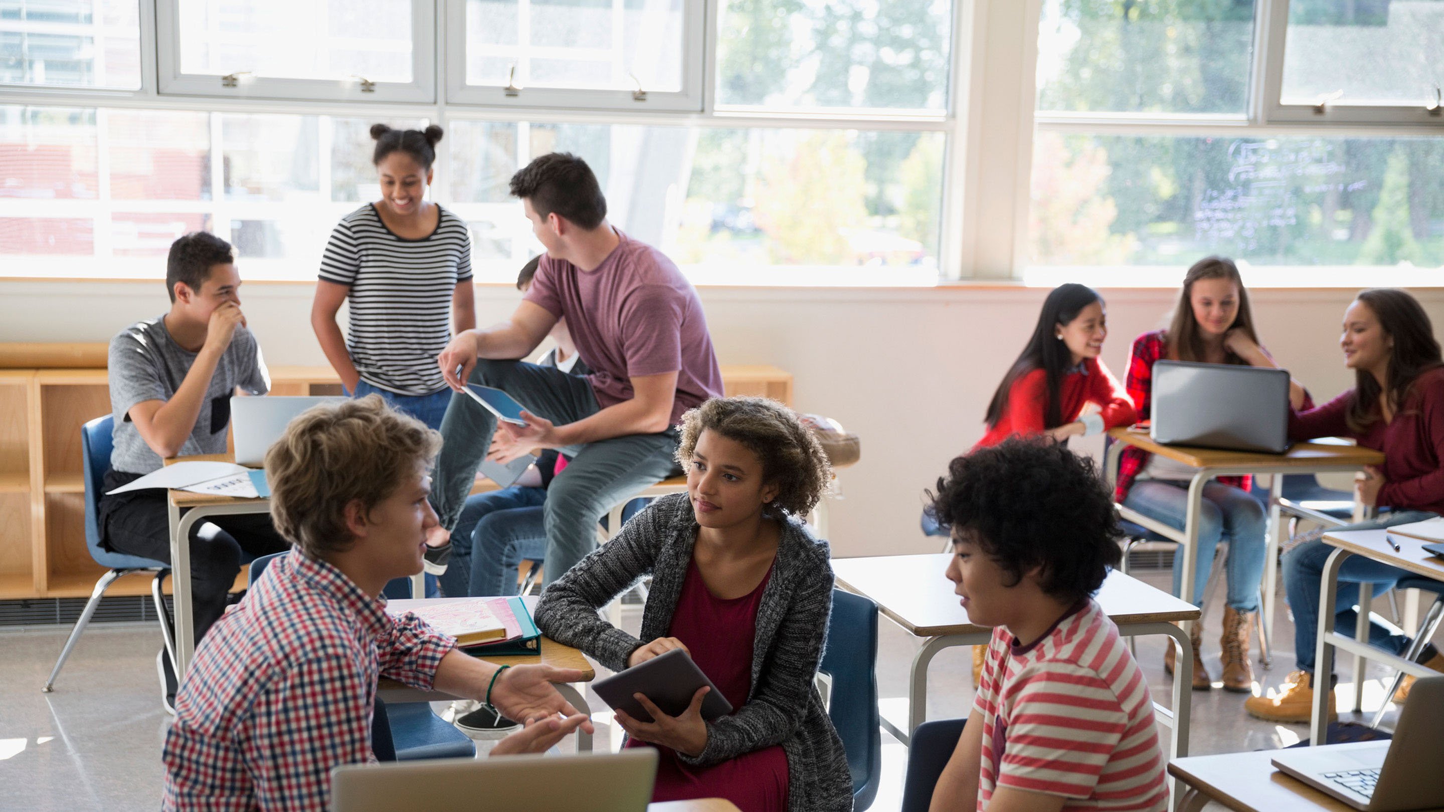An image of students in a classroom working together in small groups