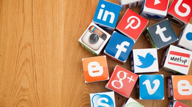 An image showing a variety of social media logos with a wood effect background