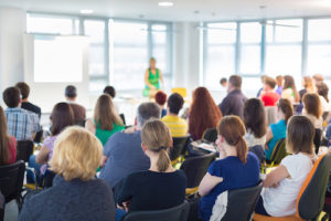 An image showing a room of teachers in a staff training session