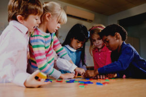 An image showing children working together on a group task